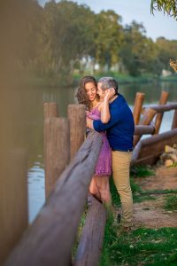 Candid photo of the engaged couple at the Yarkon River in Tel Aviv, Israel.
