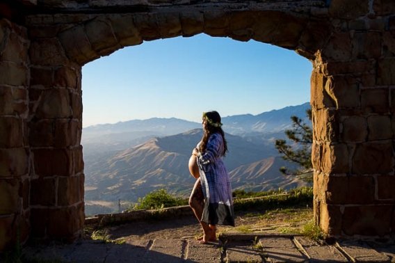 Expectant mother smiles for the camera during her maternity boudoir photoshoot at Knapp
