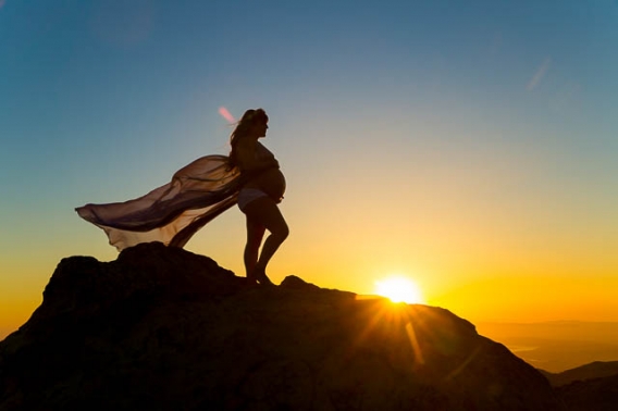 Maternity boudoir silhouette photos on top of a rock in Santa Barbara.
