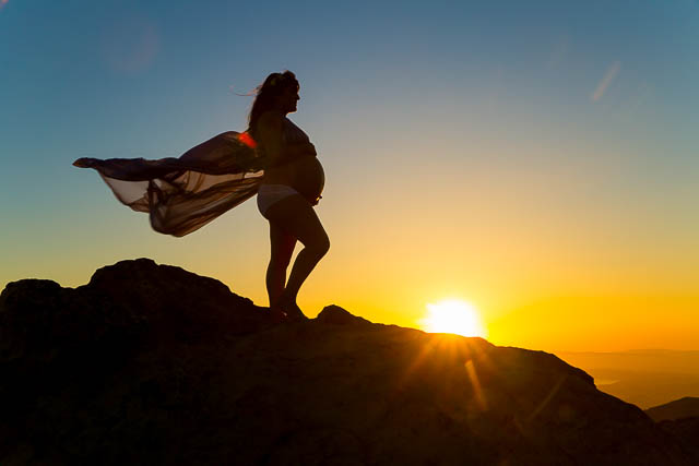 Maternity boudoir silhouette photos on top of a rock in Santa Barbara.