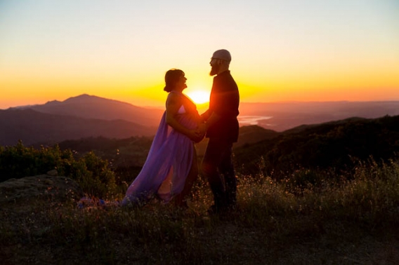 Expectant parents looking over Santa Ynez Valley during their maternity boudoir photoshoot.