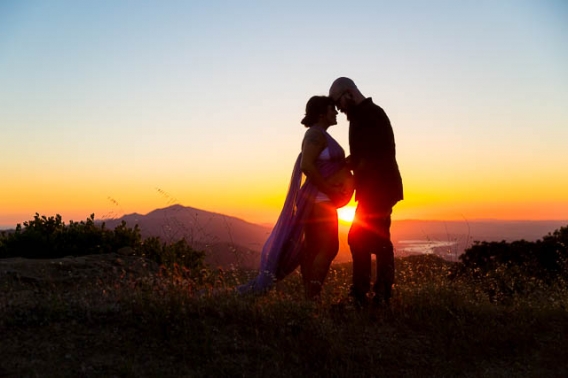 Expectant parents looking over Santa Ynez Valley during their maternity boudoir photoshoot.