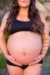 Expectant mother poses for her maternity boudoir photoshoot in Santa Barbara, California.