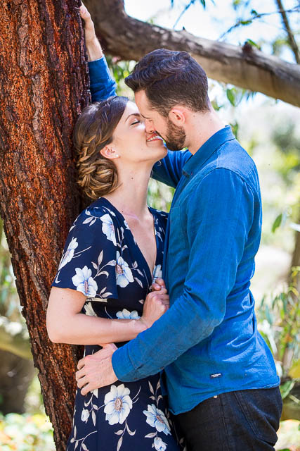 Engaged couple laughing together at the Goleta Butterfly Grove.