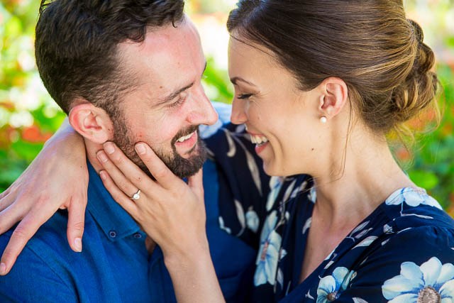 Engaged couple laughing together at the Goleta Butterfly Grove.