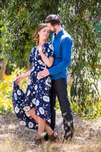 Engaged couple laughing together at the Goleta Butterfly Grove.