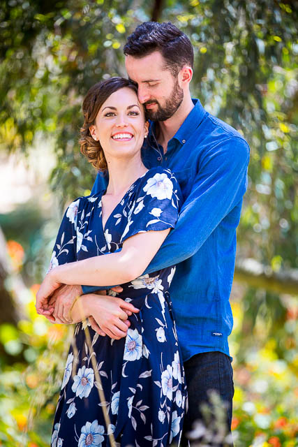 Engaged couple laughing together at the Goleta Butterfly Grove.