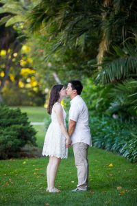 Engaged couple walking together around the Santa Barbara Courthouse grounds.