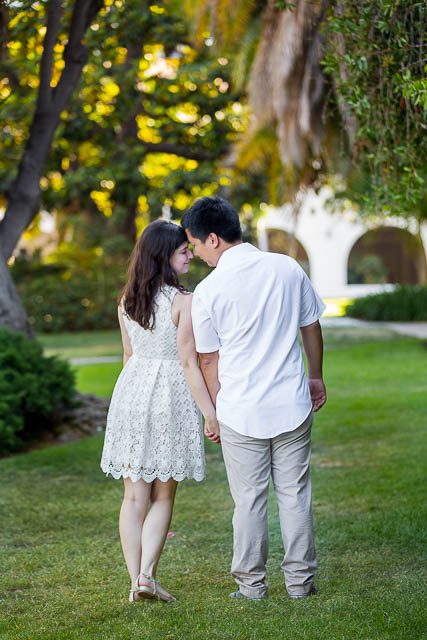 Engaged couple walking together around the Santa Barbara Courthouse grounds.