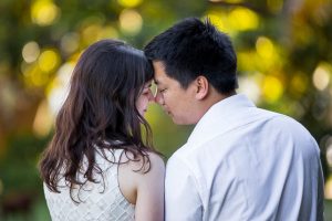 Engaged couple walking together around the Santa Barbara Courthouse grounds.