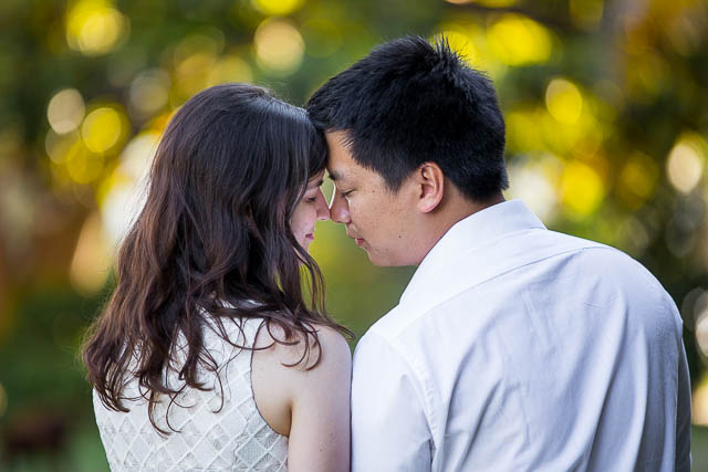 Engaged couple walking together around the Santa Barbara Courthouse grounds.