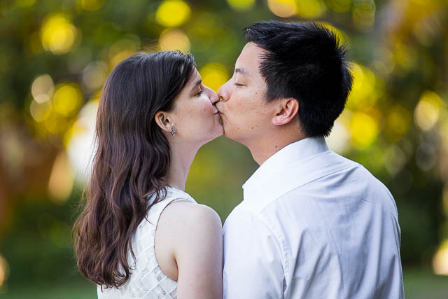 Engaged couple walking together around the Santa Barbara Courthouse grounds.
