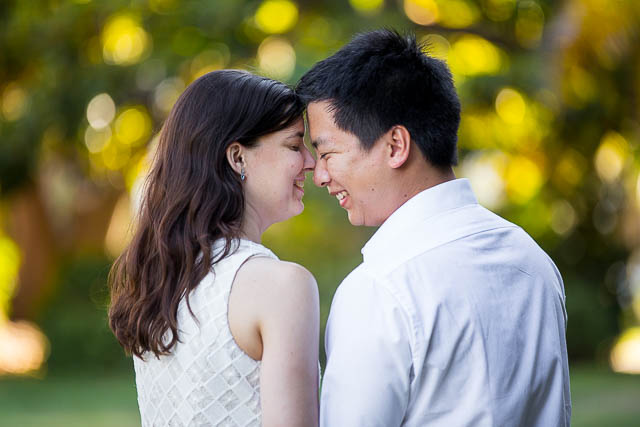Engaged couple walking together around the Santa Barbara Courthouse grounds.