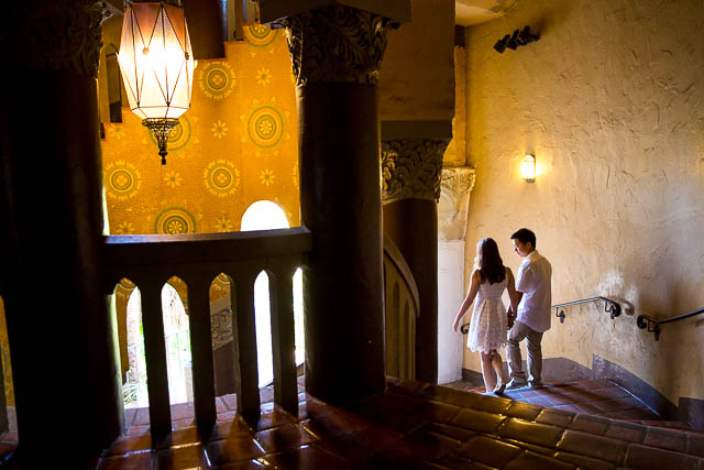 Engaged couple walking together around the Santa Barbara Courthouse grounds.