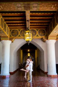 Bride and groom holding each other inside the Santa Barbara Courthouse.