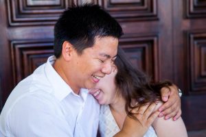 Couple holding each other during Santa Barbara Courthouse engagement photos.