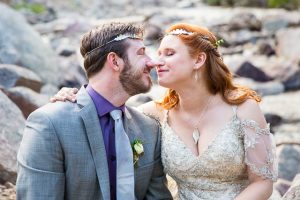Bride and groom sitting on rocks in the Colorado Rockies.