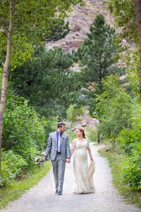Bride and groom walking together during their Boulder, Colorado, destination wedding photoshoot.