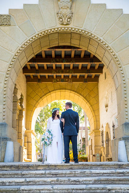 Bride and groom walking around the Santa Barbara Courthouse after their wedding ceremony.