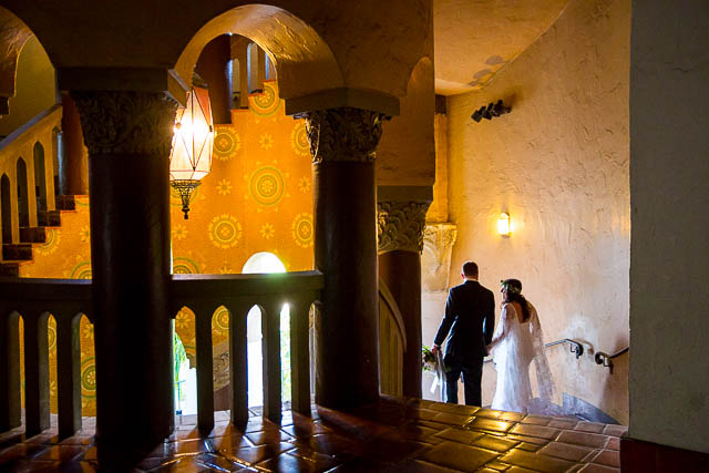 Bride and groom walking around the Santa Barbara Courthouse after their wedding ceremony.