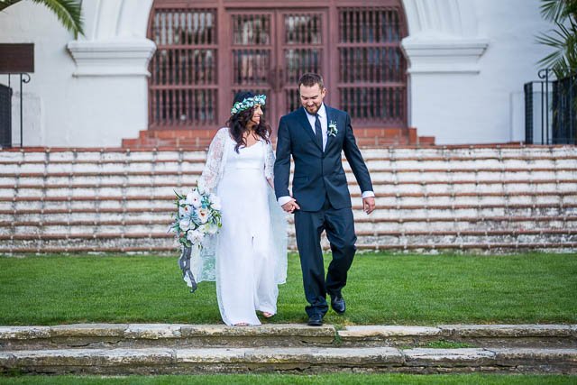 Bride and groom walking around the Santa Barbara Courthouse after their wedding ceremony.