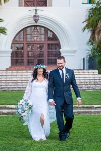 Bride and groom walking around the Santa Barbara Courthouse after their wedding ceremony.