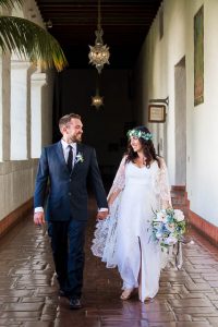 Newlywed couple walking around the interior of the Santa Barbara Courthosue.