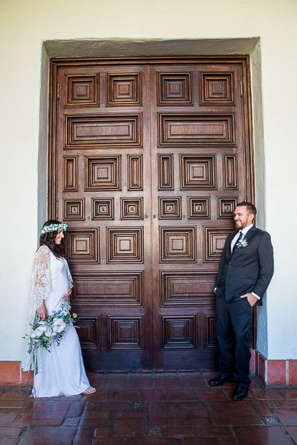 Newlywed couple walking around the interior of the Santa Barbara Courthosue.