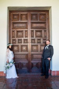 Newlywed couple walking around the interior of the Santa Barbara Courthosue.