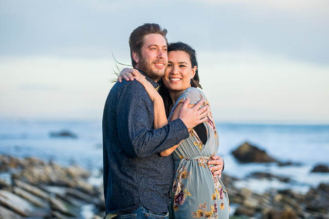 Couple hugging at their Hendry's Beach engagement photoshoot in Santa Barbara, CA.