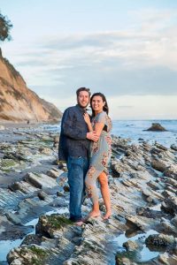 Couple hugging at their Hendry's Beach engagement photoshoot in Santa Barbara, CA.