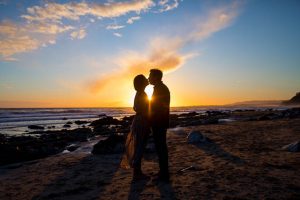 Sunset photos of engaged couple at Hendry's Beach.