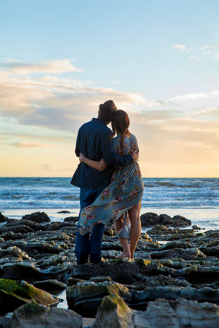 The newly engaged couple at Hendry's Beach rocks.