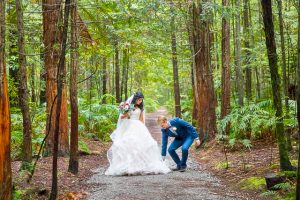 Bride and groom walk together through the Rotorua Redwoods Forest in New Zealand.