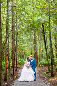 Bride and groom walk together through the Rotorua Redwoods Forest in New Zealand.