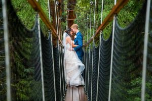 The bride and groom hugging on a bride at the Rotorua Redwoods Treewalk.