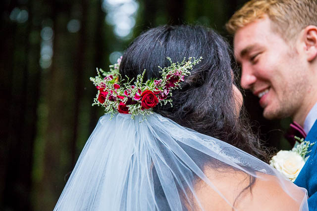 Bride and groom snuggling at the Rotorua Redwood Forest.