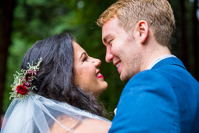 Bride and groom snuggling at the Rotorua Redwood Forest.