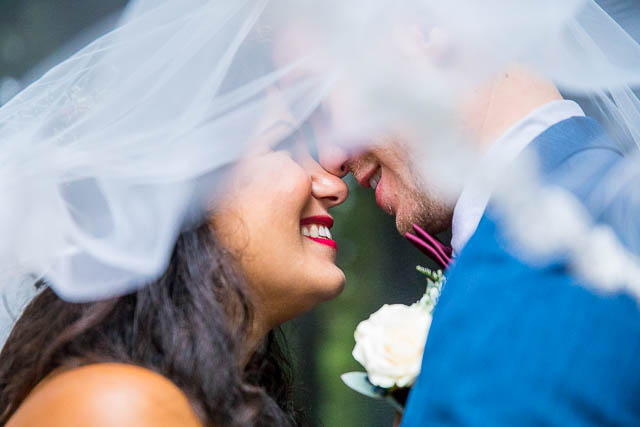 Bride and groom snuggling at the Rotorua Redwood Forest.