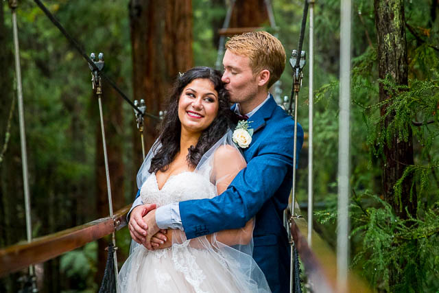 Newlyweds holding each other at the Rotorua Redwoods Treewalk. 