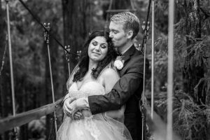 Newlyweds holding each other at the Rotorua Redwoods Treewalk.
