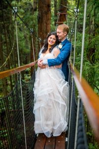 Newlyweds holding each other at the Rotorua Redwoods Treewalk.