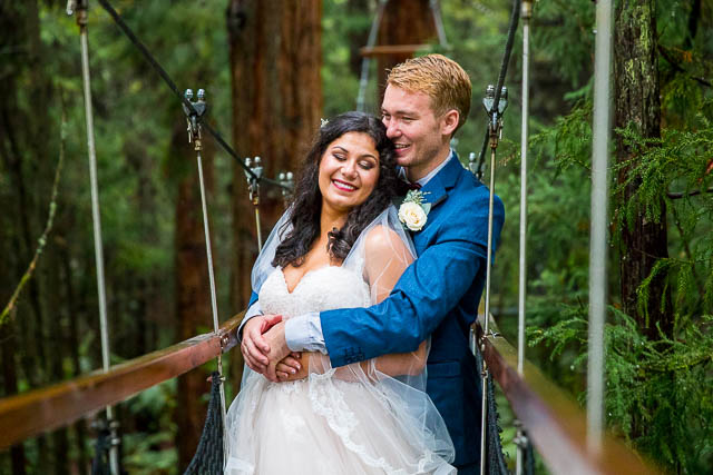 Newlyweds holding each other at the Rotorua Redwoods Treewalk.