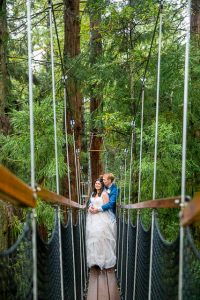 Newlyweds holding each other at the Rotorua Redwoods Treewalk.
