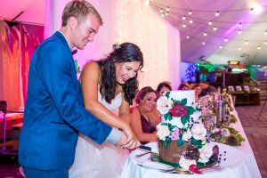 Bride and groom cutting the cake at their Skyline Rotorua wedding reception.