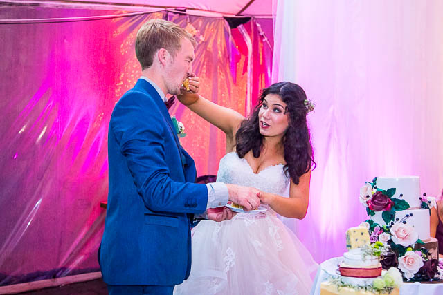 Bride and groom cutting the cake at their Skyline Rotorua wedding reception.
