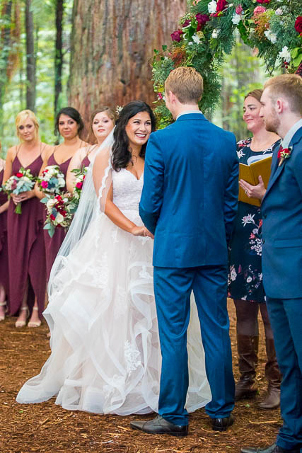 Bride reading her vows at her Rotorua Redwoods Under the Sails wedding ceremony