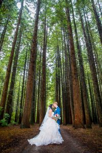 Newlyweds hug in the Rotorua Redwoods Forest after their Under the Sails wedding ceremony in Rotorua, New Zealand.