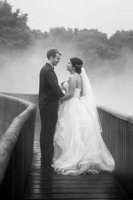 Bride and groom walking around the geothermal Kuirau Park in Rotorua, New Zealand.