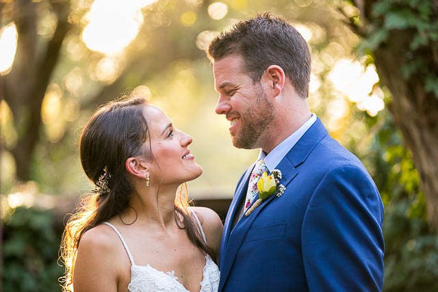 Newlyweds taking romantic sunset photos during their Ojai The Ranch House wedding reception.